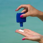 Woman hands putting a beauty product